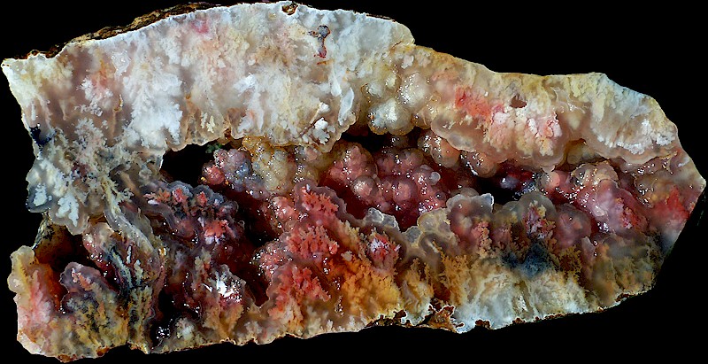 This agate is white, transparent, pink, orange, cram, and brown.