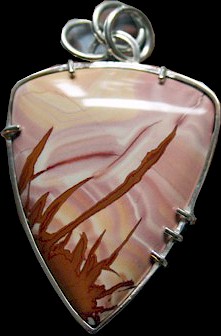 A pink, cream, and brown rock that was made into a pendant.