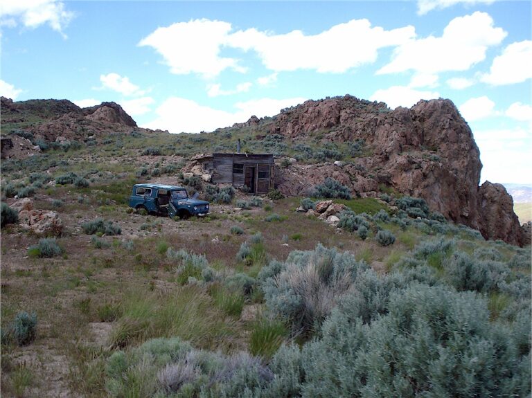 An old cabin and vehicle